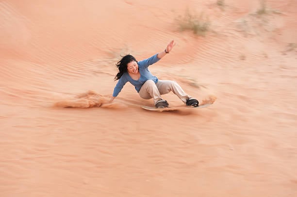 Sandboarding in Merzouga desert Erg Chebbi Morocco