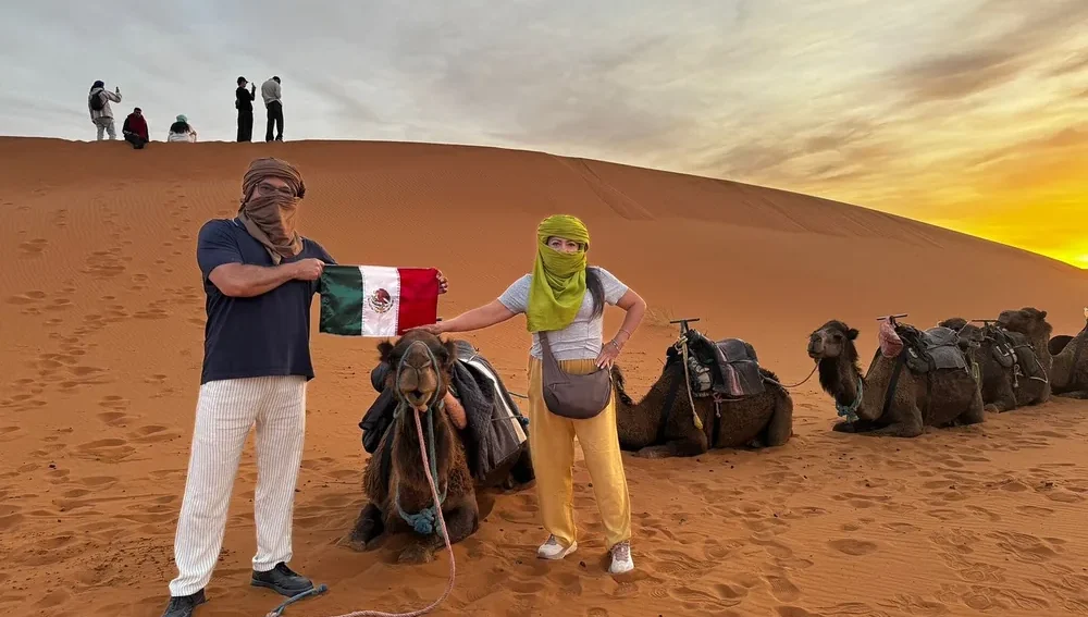 Camel trek at sunset in the Merzouga Sahara Desert during a 2 days tour from Marrakech to Merzouga.