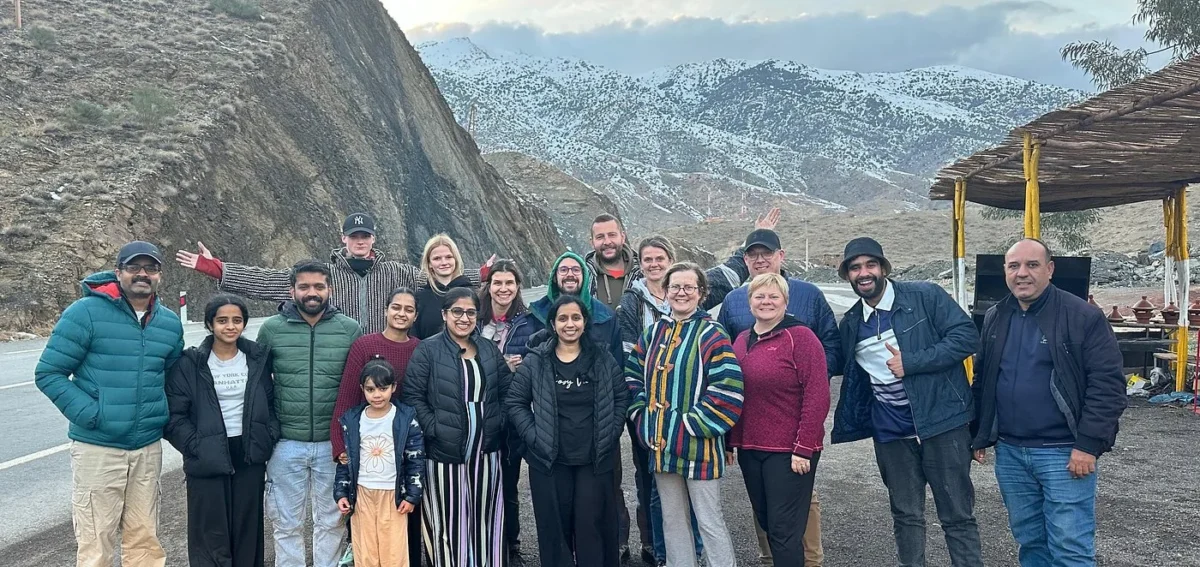 Travelers on the High Atlas Mountains route during a 3 days desert tour from Marrakech to Fes via Merzouga