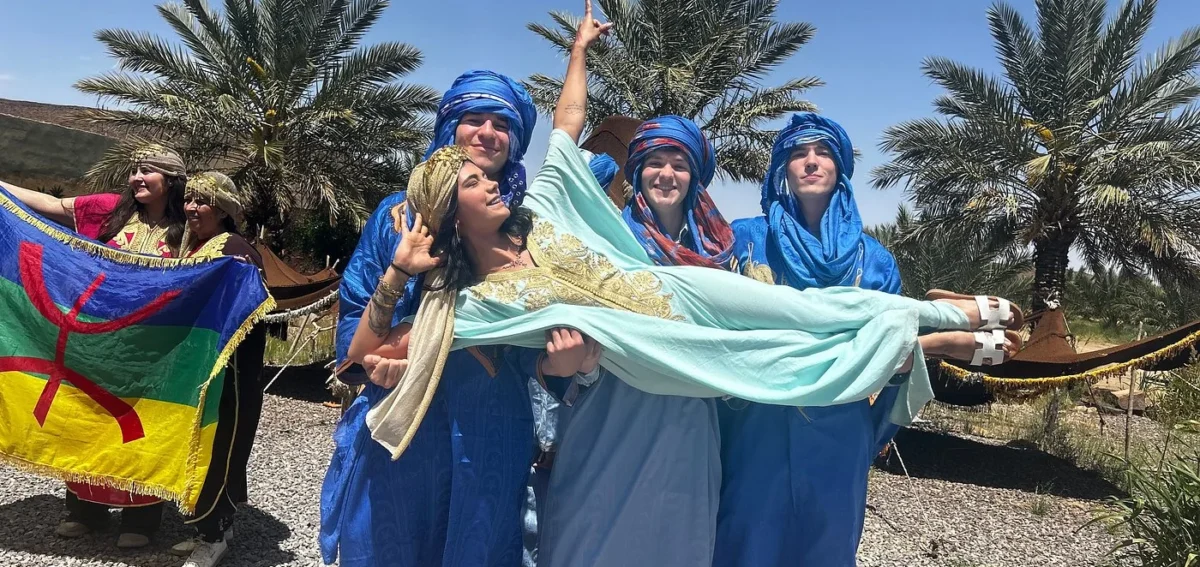 Travelers enjoying Gnawa music and local culture in Khamlia village near Merzouga