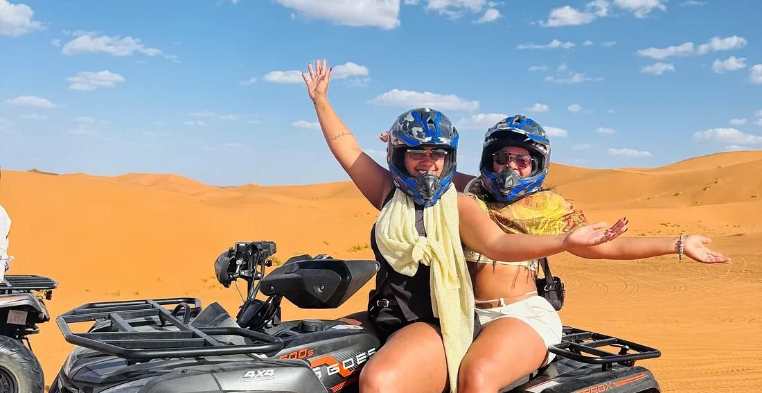 Travelers enjoying quad biking in the Merzouga Sahara Desert near Erg Chebbi dunes