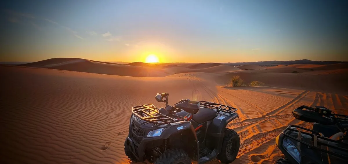 Quad biking in Erg Chebbi dunes at sunset during the 5 days Marrakech to Fes desert tour via Merzouga