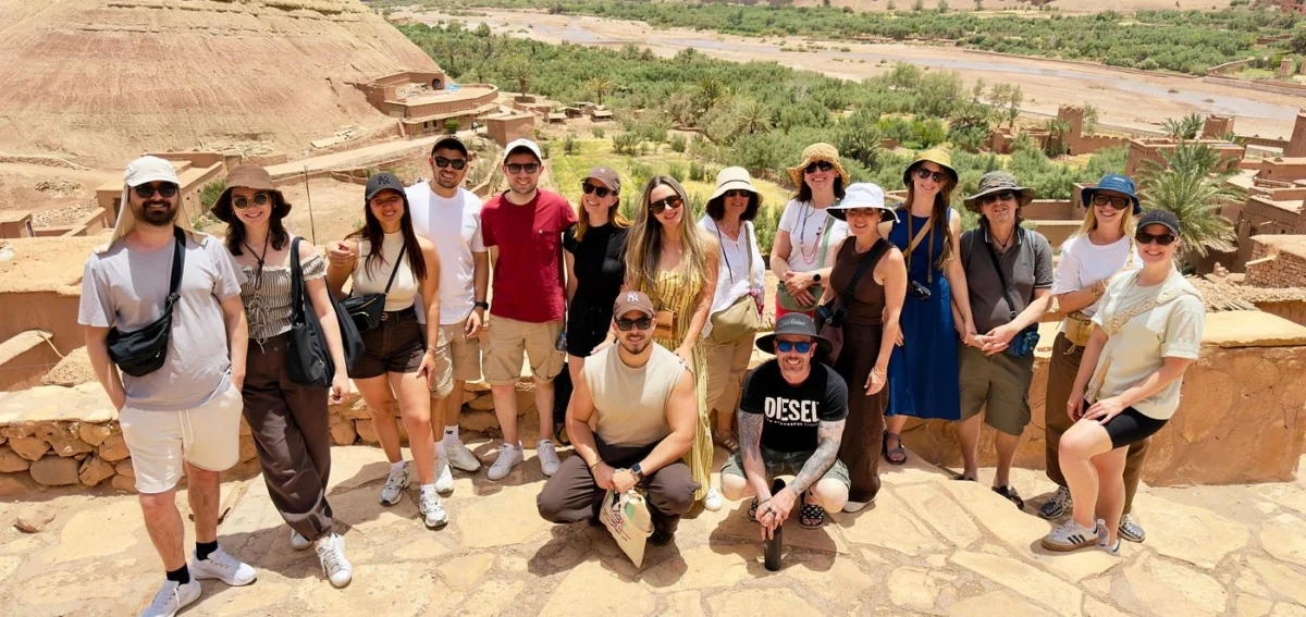 Group photo at Ait Ben Haddou during the 8 days Morocco desert tour from Marrakech