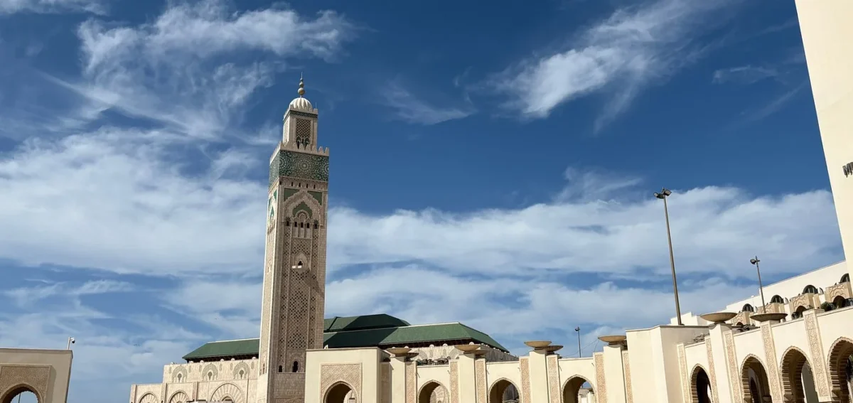 Hassan II Mosque courtyard and minaret in Casablanca beneath a blue sky