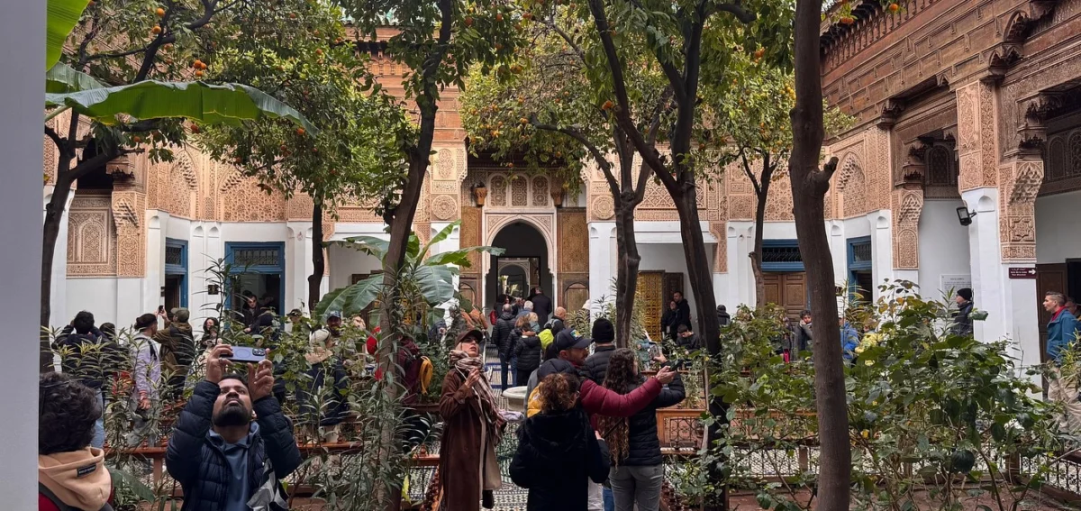 Guided visit of a historic palace courtyard in Marrakech during the 8 days Morocco desert tour from Marrakech