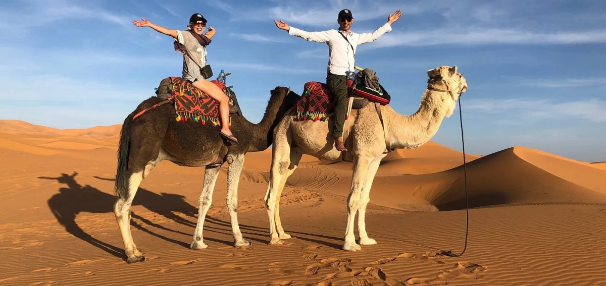 Camel ride in Merzouga dunes during a 3 days tour from Errachidia to Merzouga Desert at sunset.