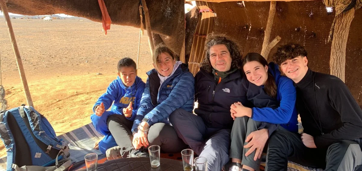 Family visiting a traditional nomadic tent during a Merzouga desert tour