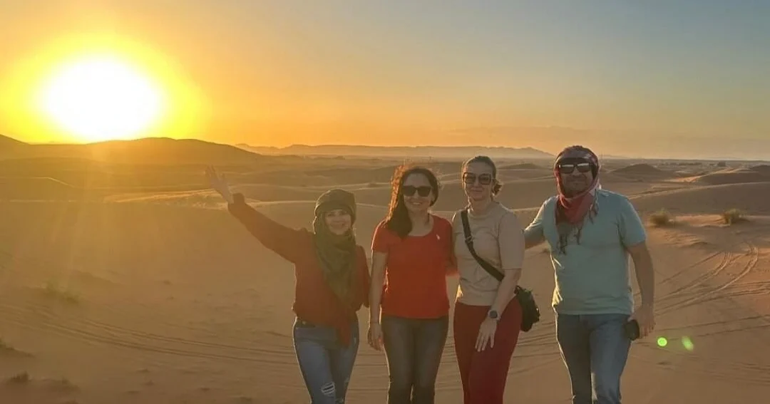Travelers enjoying sunset during the 3 days tour from Ouarzazate to Merzouga in the Sahara Desert of Morocco