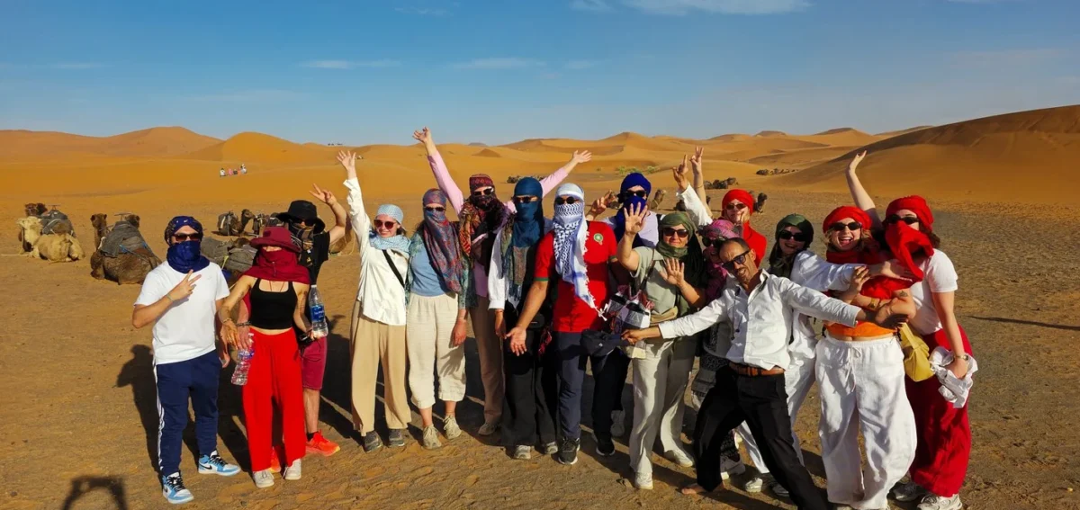 Travelers enjoying a group Sahara desert tour in Merzouga Morocco