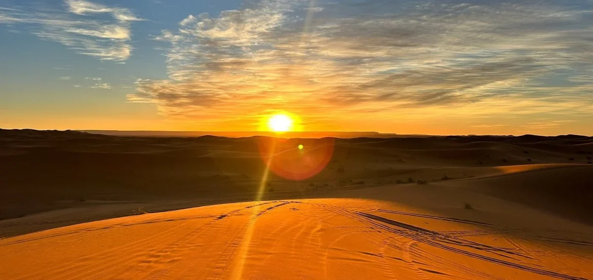 Sunset over the sand dunes of Merzouga during a Sahara desert tour in Morocco