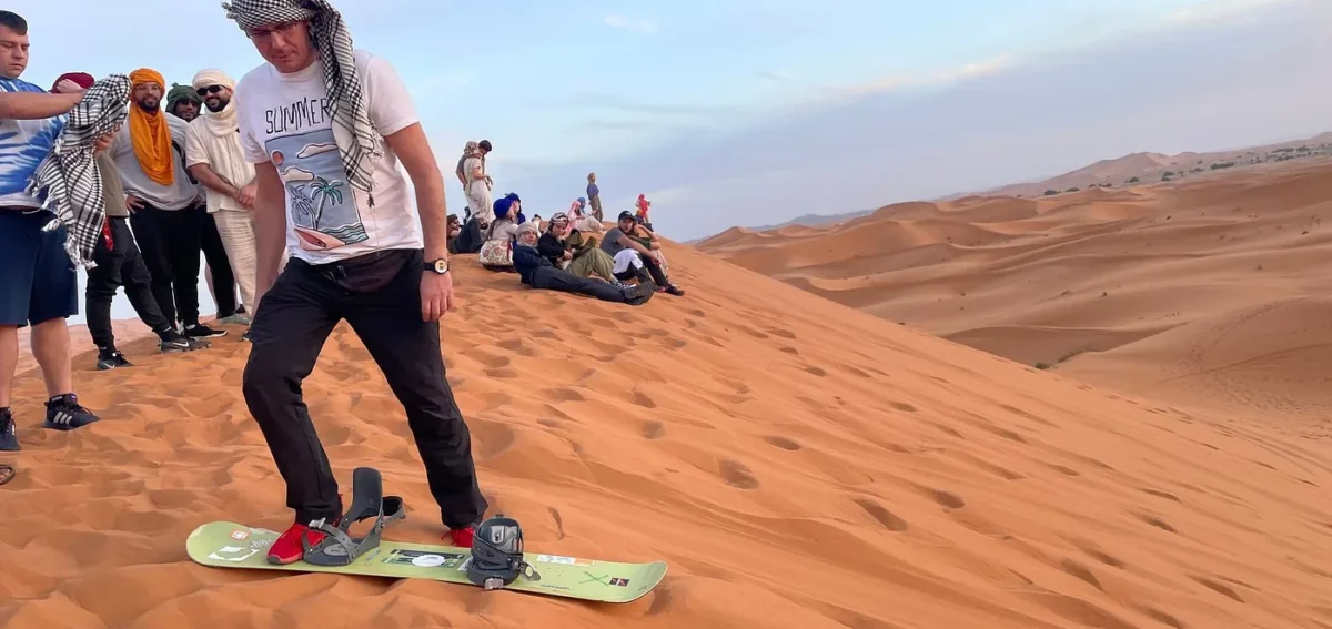 Sandboarding on the Erg Chebbi dunes during the 3-day Ouarzazate to Fes tour