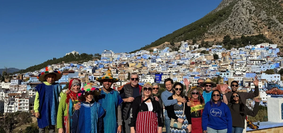 Group photo in Chefchaouen during a 7 days Morocco tour from Rabat to Marrakech.